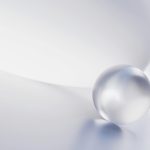 A crystal ball rests on a curved surface.