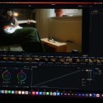 a computer screen showing a man sitting in a chair